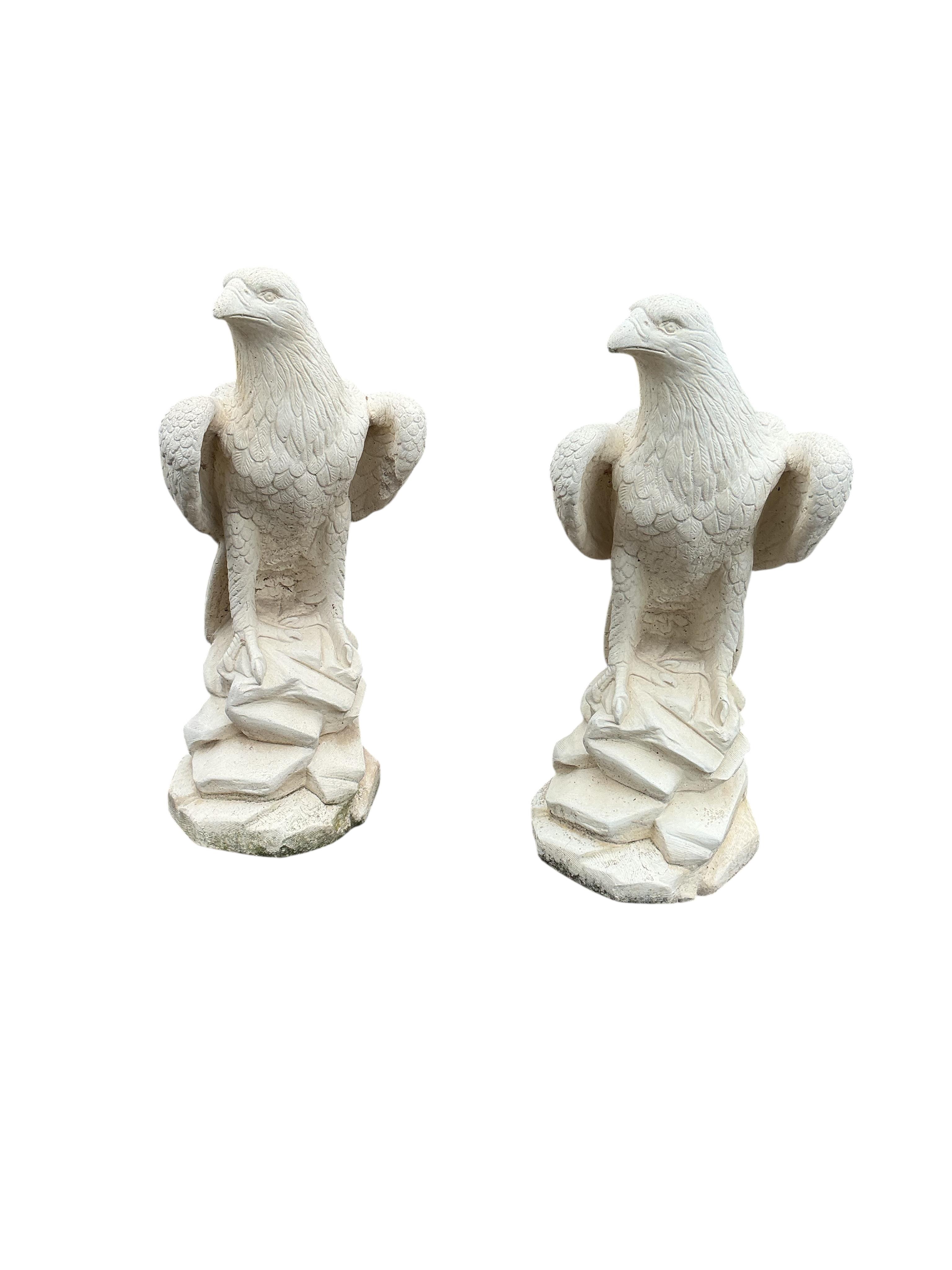 A pair of reconstituted stone eagle garden ornaments, height 60cm